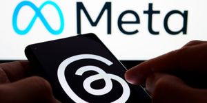 Threads Logo on Smartphone with Meta Logo in Background