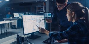 Two mechatronics engineers working on a task collaboratively