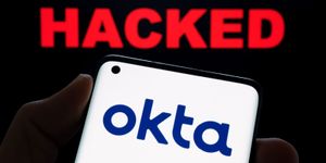 Okta Logo on Smartphone screen, with hacking background