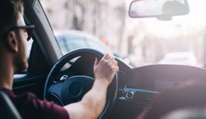 Yound man driving a car